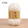 A ball of cream-colored cotton blend crochet yarn labeled 26-white.