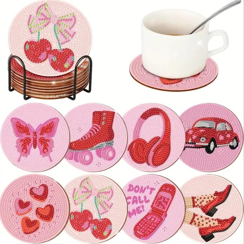 A set of pink diamond painting coasters featuring various designs like apples, butterflies, headphones, and shoes with a meta