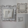 A decorative silver frame surrounds a white switch cover plate with two light switches.