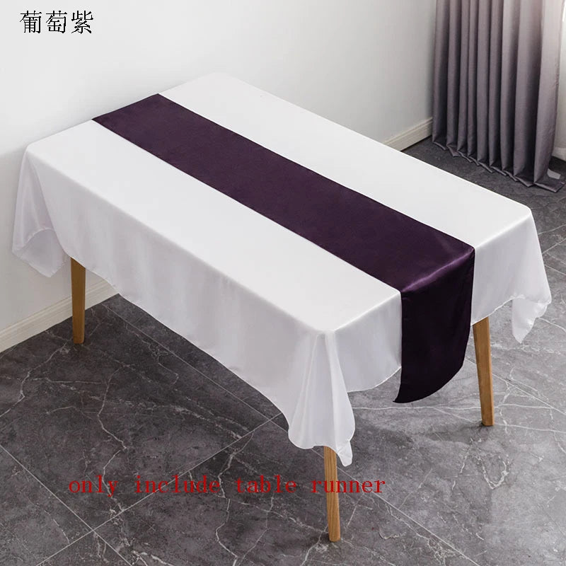 Elegant satin table runner in white and deep purple on a rectangular table.
