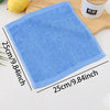 A blue microfiber cleaning cloth is shown next to a wooden board and a bamboo container.