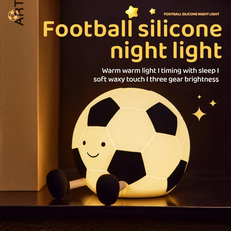 A glowing yellow football silicone night light resting on a dark surface.