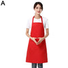 A woman models a red waterproof apron with a front pocket over a white shirt.
