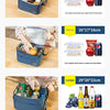 A blue insulated lunch bag with a shoulder strap is shown open, containing various food items and lunch boxes.
