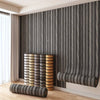 Vertical wood grain peel-and-stick wall tiles in gray and beige tones installed on a modern interior wall.
