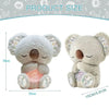 A soft gray koala plush toy with closed eyes and pink accents, shown from the front.