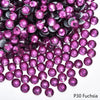 A close-up view of small magenta rhinestones scattered on a white background.