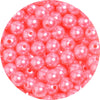 A close-up view of small, round, pink imitation pearl beads for jewelry making.