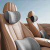 A professional chiropractic set featuring memory foam car headrest and lumbar support pillows in a tan leather interior.