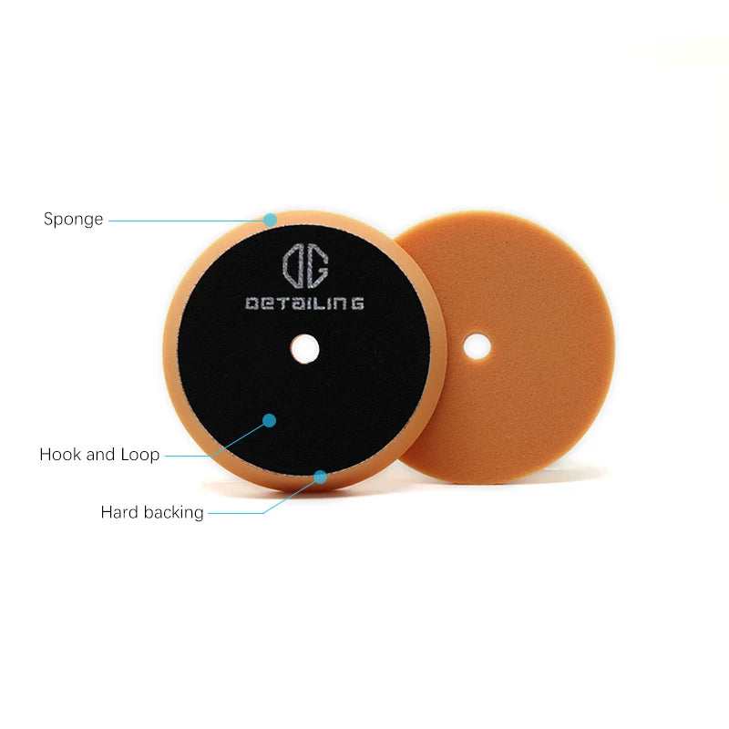 A set of foam polishing pads for car detailing showing a black sponge and an orange pad with a hook and loop.