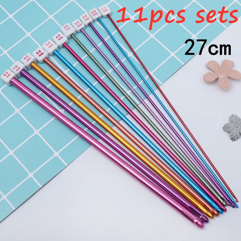 A set of 11 pairs of crochet hooks with various sizes and colors arranged on a blue grid.
