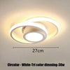 Circular white LED ceiling light with tri-color dimming feature mounted on a ceiling.