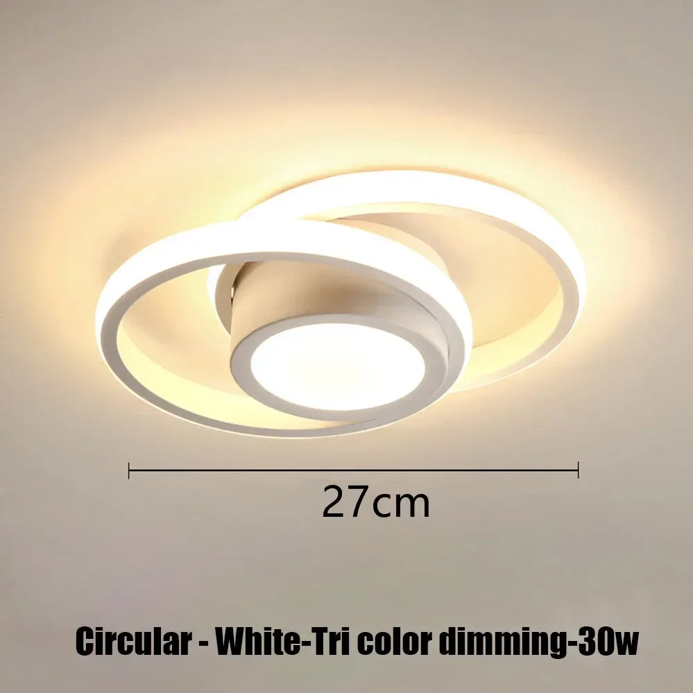 Circular white LED ceiling light with tri-color dimming feature mounted on a ceiling.