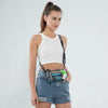 A woman models a clear stadium-approved crossbody bag with an adjustable strap and a collection of pens and small items.