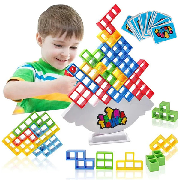 A boy is playing with a set of colorful stacking tower balance game blocks and cards.