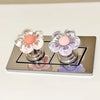 A set of elegant floral toilet flush handles in shades of pink and purple mounted on a silver plate.