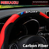 Black steering wheel with a red and blue Sport cover made of carbon fiber