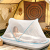 A white mosquito net is set up inside a tent, providing a protected sleeping area for camping or travel.
