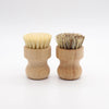 Two wooden dish scrub brushes made with natural sisal bristles are shown side by side.