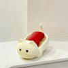 A white cat-shaped soap box with a red drainage tray sits on a white surface.