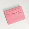 A pink genuine leather slim card holder wallet shown from above.