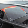 A stack of colored microfiber car drying towels rests on a dark car surface.