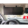 A black leather car sun visor extender is mounted on the ceiling of a vehicle.