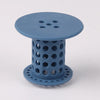 A light blue flexible hair catcher drain cover with a perforated top and cylindrical body.