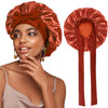 A woman wearing a satin sleeping bonnet in a burnt orange color with an adjustable tie.