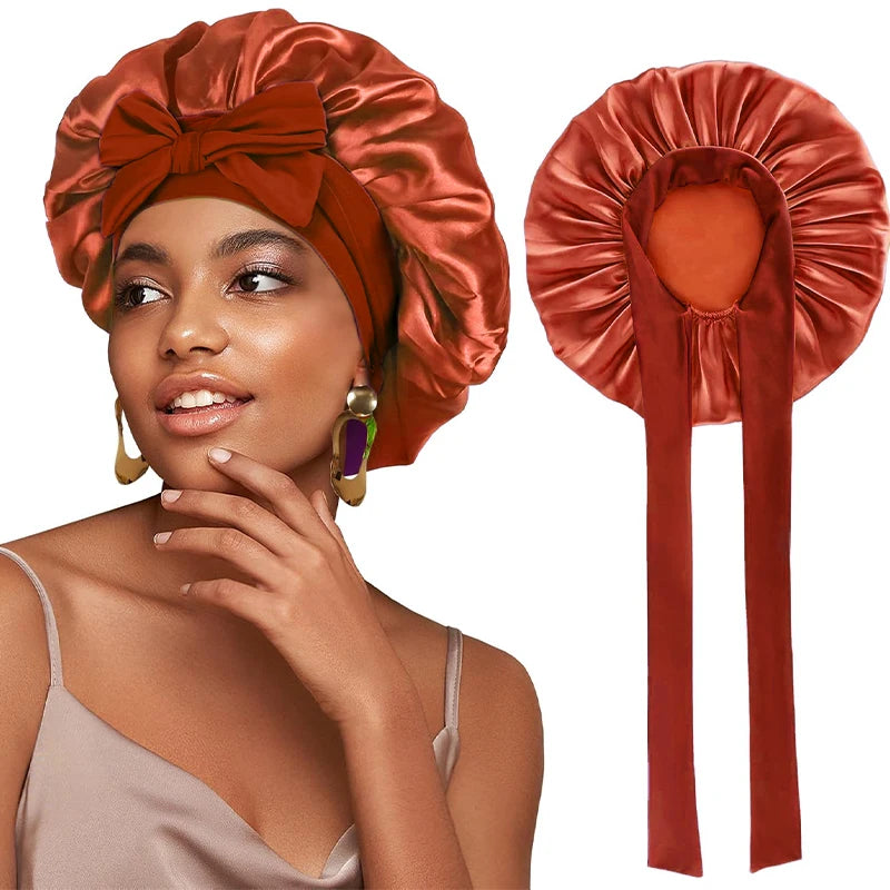 A woman wearing a satin sleeping bonnet in a burnt orange color with an adjustable tie.