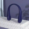 A purple hands-free bladeless neck fan with a digital display is shown resting on a white textured surface.