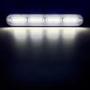 A bright white LED strobe warning light bar illuminates a dark surface.