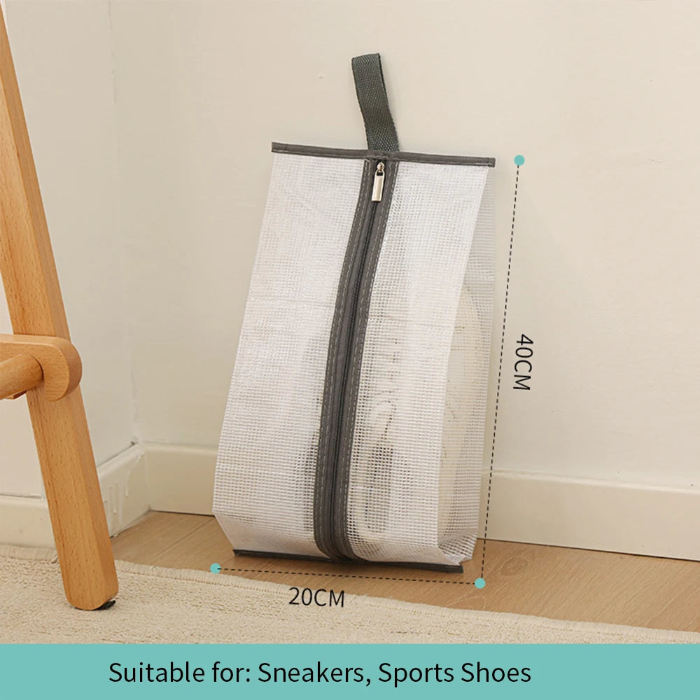 A white mesh waterproof boot storage bag with a gray zipper and handle, shown next to a wooden object.