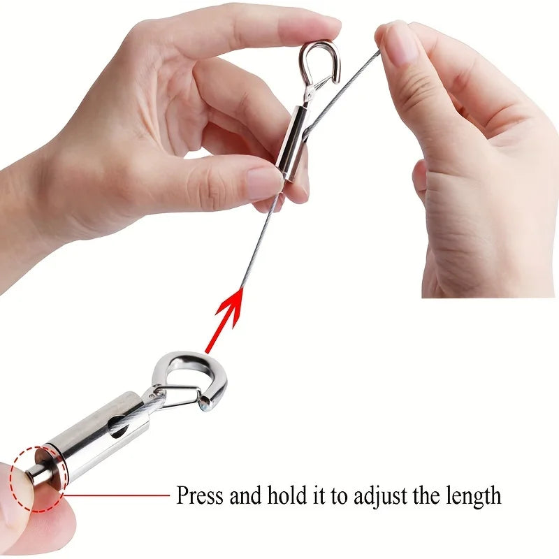 Hands demonstrate how to press and hold an adjustable stainless steel cable hanging kit to set the desired length.