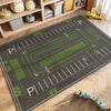A green and gray play mat depicting a road with traffic markings for children's play.