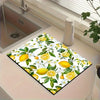 A square mat featuring a vibrant yellow lemon and white floral pattern used for kitchen or laundry