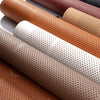 A close-up view of several breathable leather car seat cushions in various shades including brown, beige, and pink.
