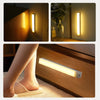 A modern LED bar light is mounted on a wooden wall panel, illuminating the area with warm light.