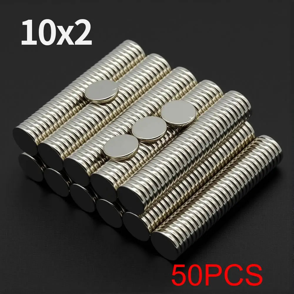 A pile of 50 pairs of silver disc magnets, packaged as 10x2, showing the shiny metal and threaded ends.