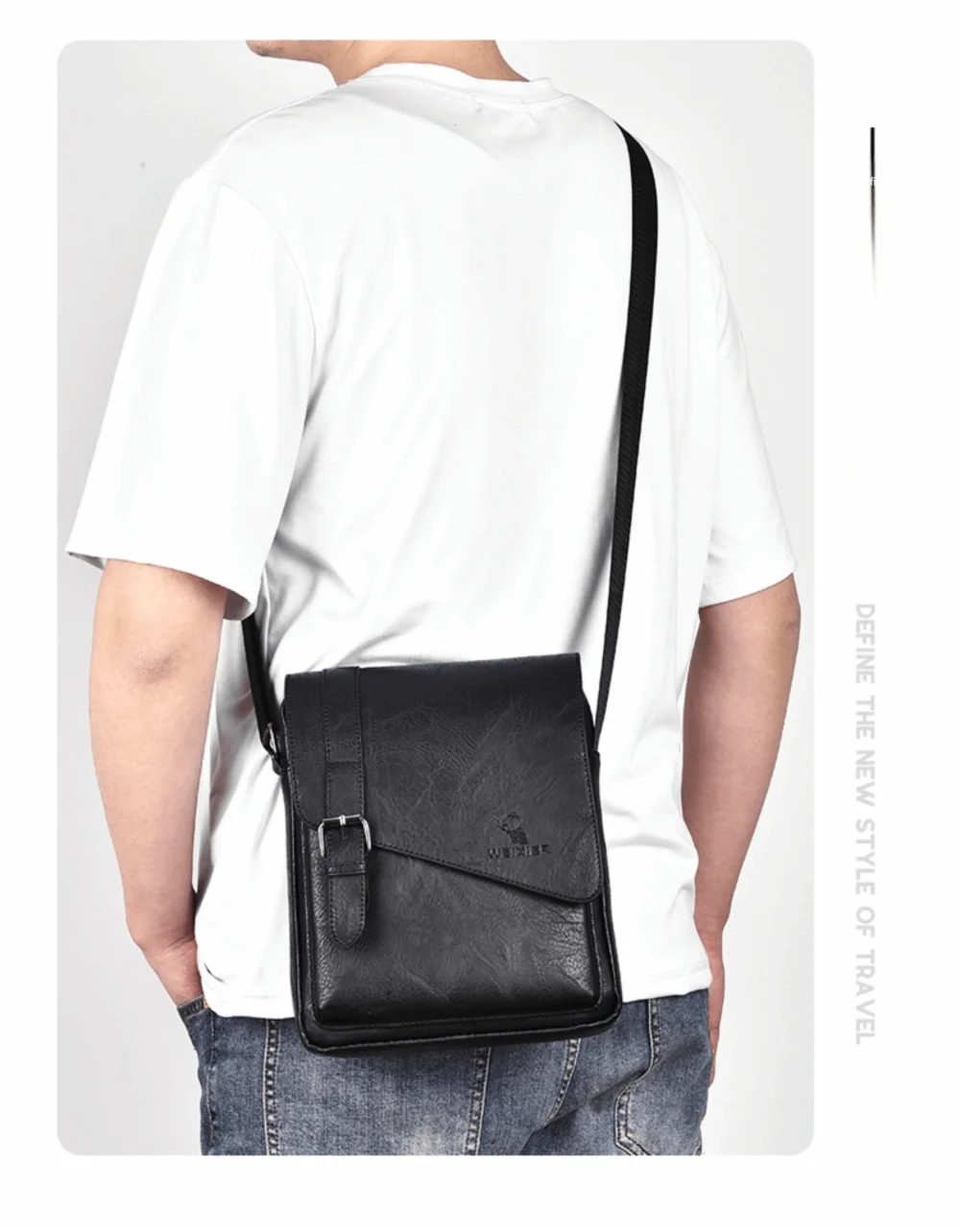 A man wearing a white t-shirt is holding a black PU leather messenger bag with an adjustable strap.
