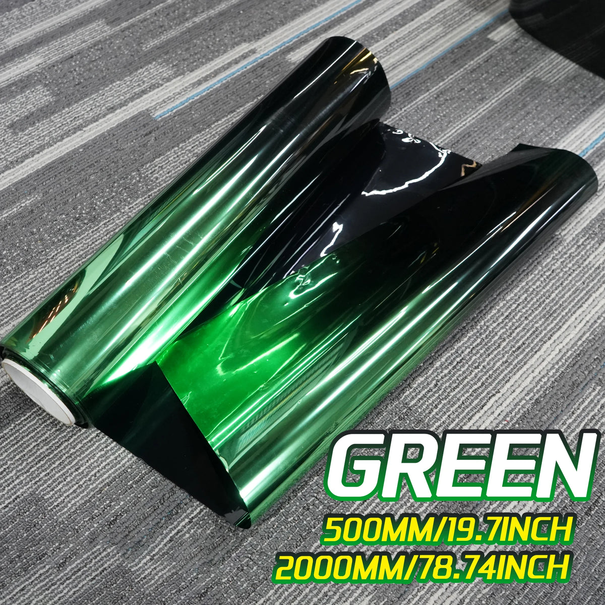 A roll of green gradient car window tint film is shown on a gray surface.