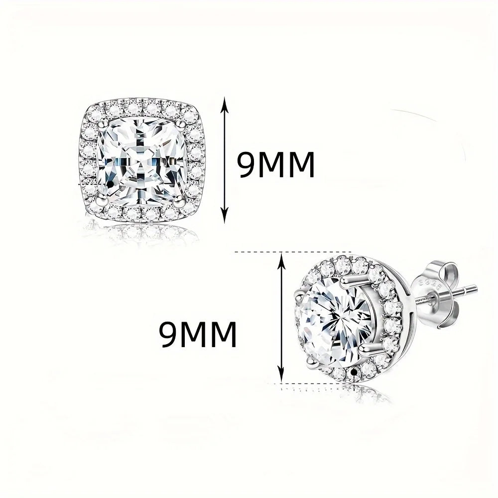A close-up view of silver-tone cubic zirconia stud earrings, showing a round brilliant gemstone and a detailed earring settin