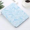 A light blue marble patterned case for an iPad Pro with a built-in pencil holder.