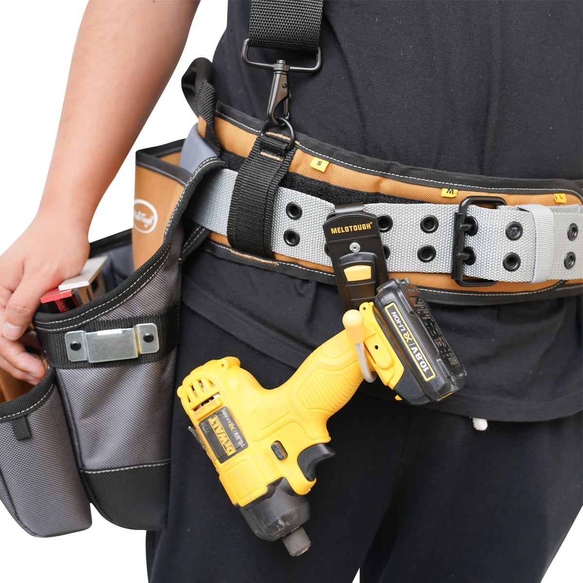 A yellow Dewalt cordless drill is visible inside a black and tan holster attached to a tactical belt.