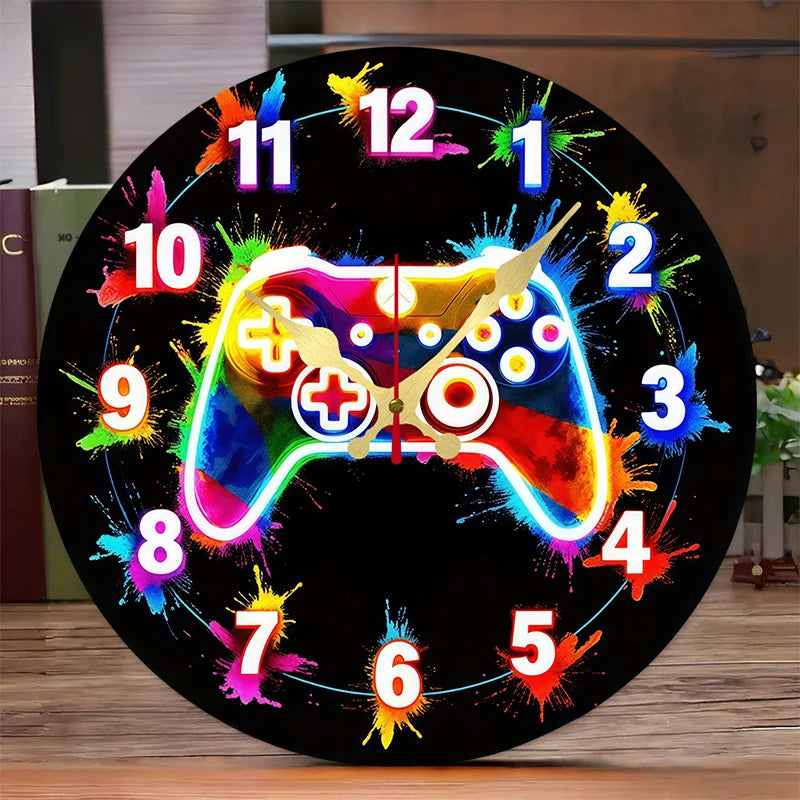 A black wall clock face displaying a colorful video game controller design with numbers and hands.