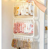A white multi-clip space-saving laundry drying rack hanging on a closet rod, holding various folded garments.