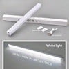 A white LED light bar is shown alongside its magnetic patch and USB charging cable.