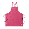 A bright pink canvas apron with straps and two front pockets.