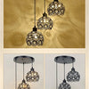 A set of crystal single-head ceiling lamps with metal frames hanging against a golden background.