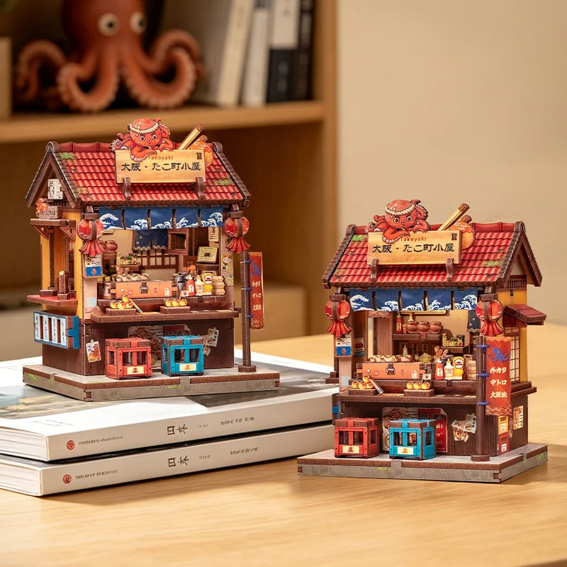 A detailed miniature kit of a Japanese book nook featuring a traditional building with lighting elements.